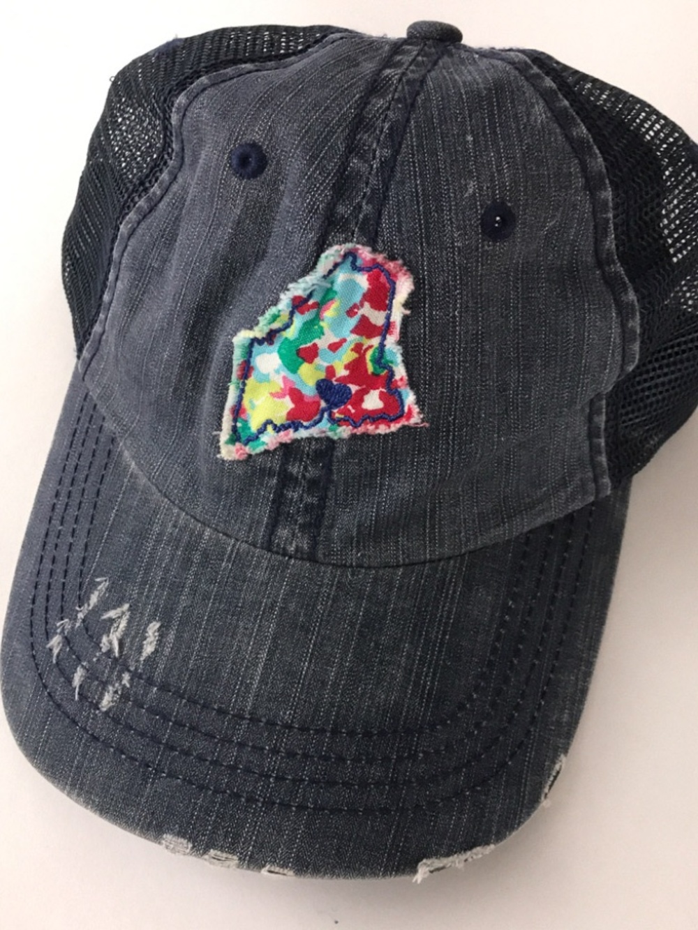 Maine state outline in colorful fabric hat blue unstructured trucker cap